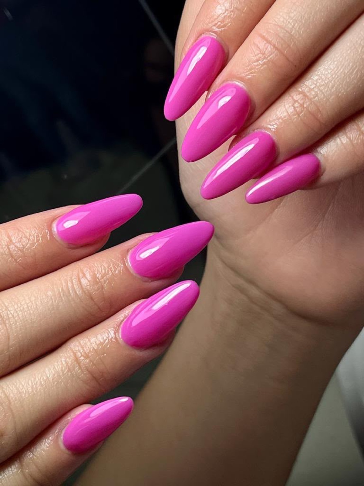 Glossy bright pink almond nails